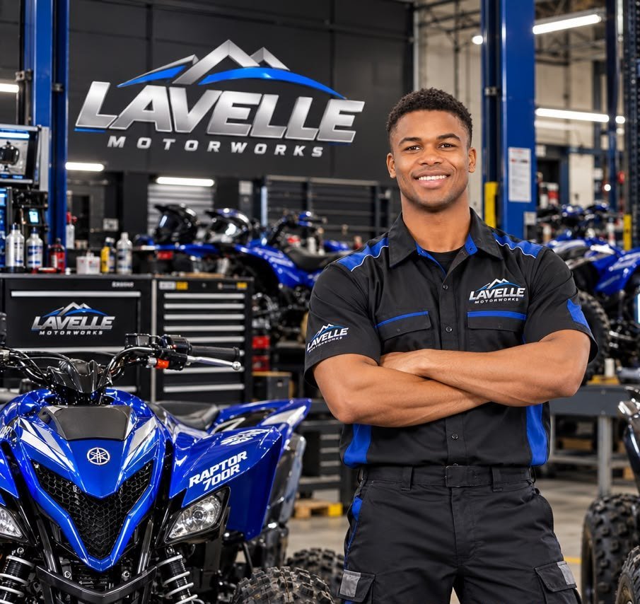 Illustration of a technician in a Lavelle Motorworks shirt beside a blue Raptor 700R